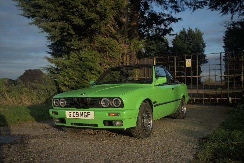 Photo of a green E30, processed from RAF with Darktable's default settings.